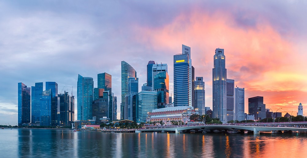 A wide shot of the Singapore skyline at sunset.