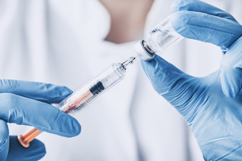 Close-up of a doctor preparing a vaccine.