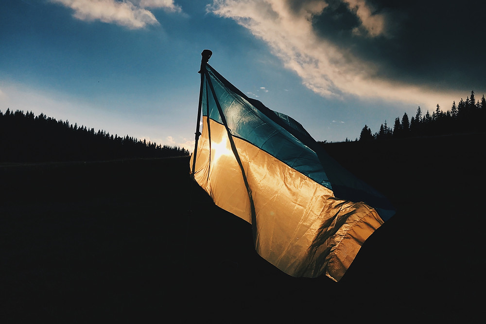 A photo of the Ukrainian flag, backlit by the sun.