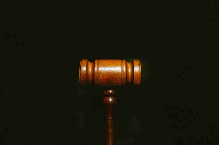 A judge's gavel centered on a black background.